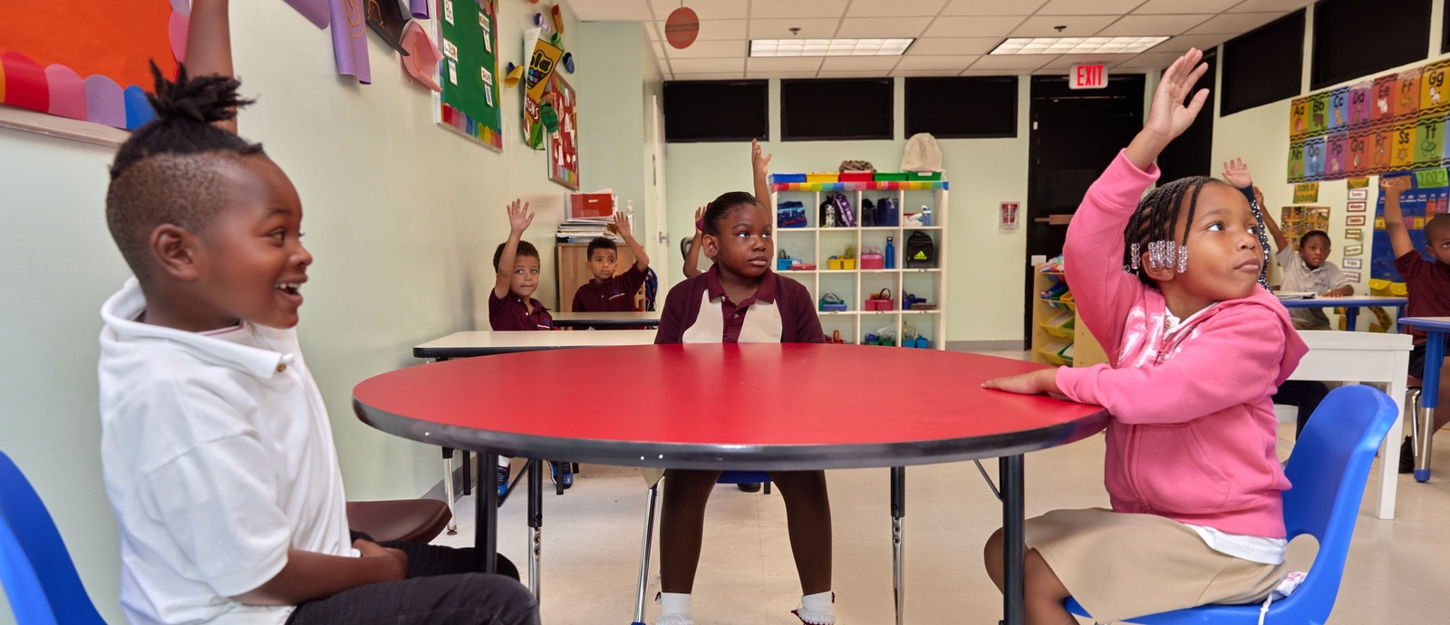Child and adult looking at tablet
